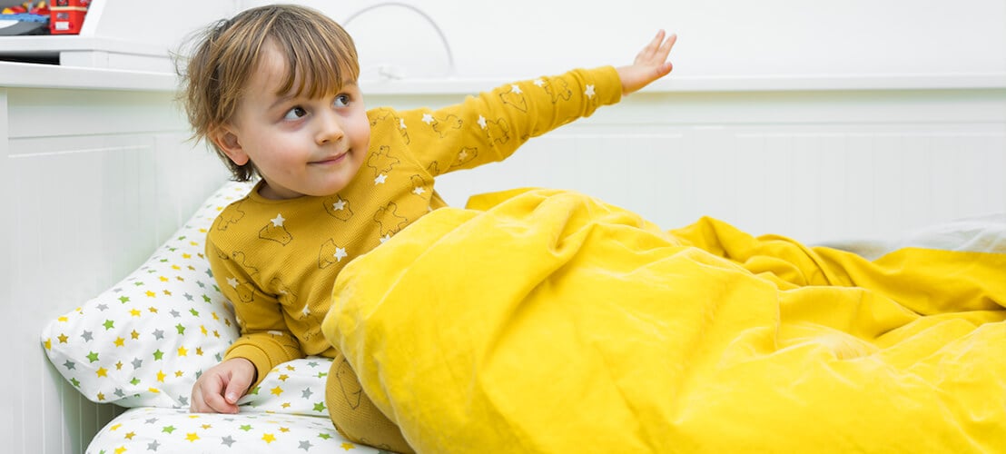 Image d’un enfant de 3 ans dans son lit